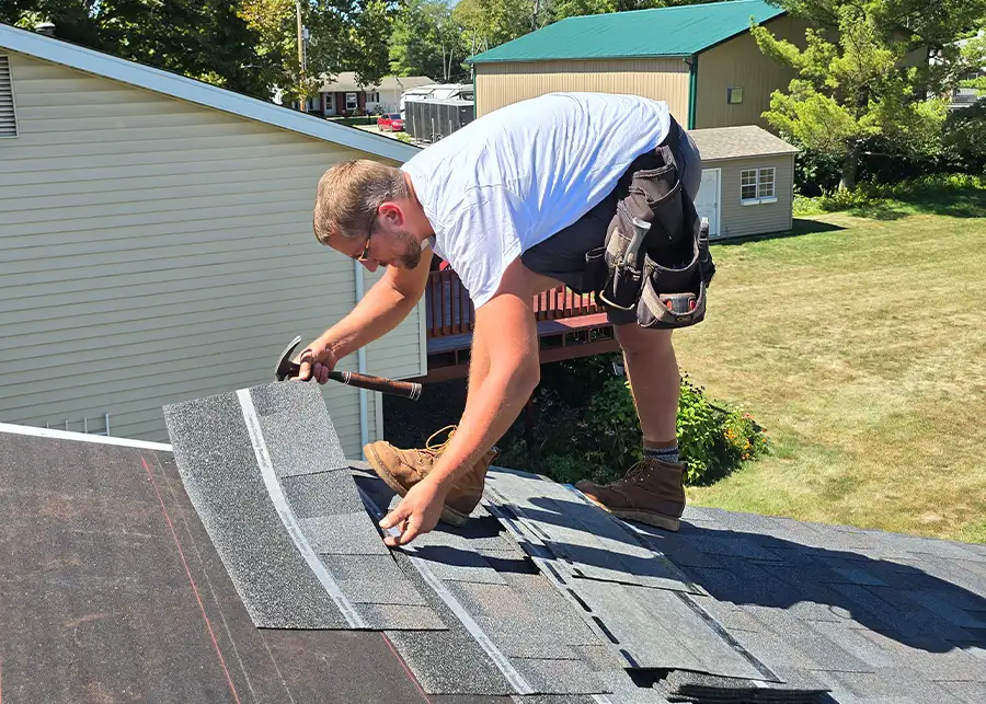 Tom Skelley Roofing Inc. hand-nailing shingles onto residential roof - Decatur, IL